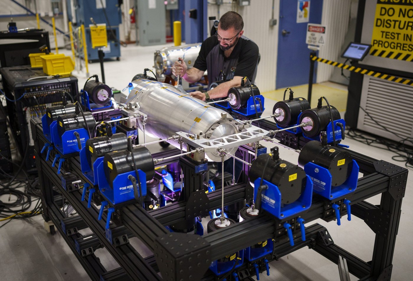 Kevin Cross torquing a fixture bolt on a multi-axis shock and vibration test frame at Sandia National Laboratories